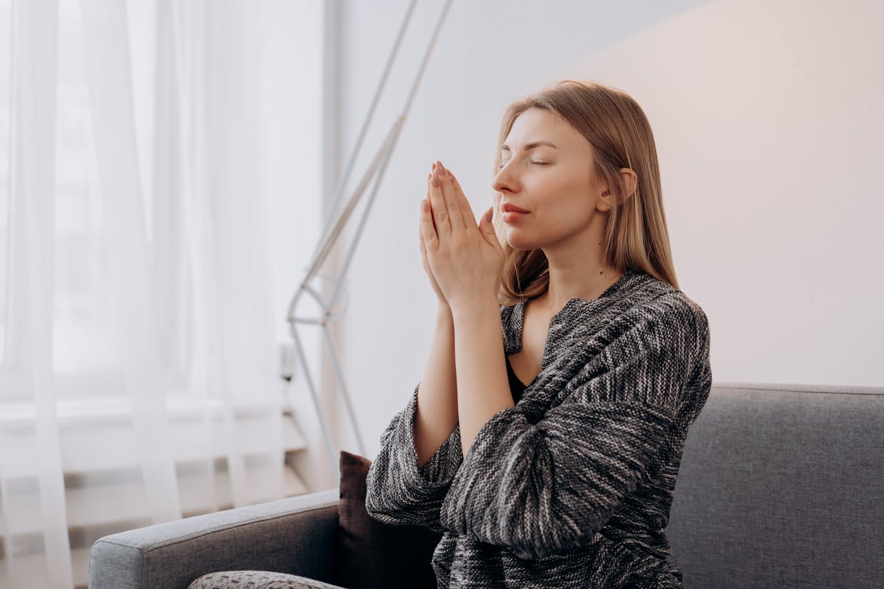 services-03 A woman meditates peacefully indoors, seeking relaxation and inner peace through mindful practices.